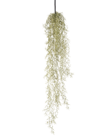 En konstgjord hängväxt Gräs 91 cm med långa, släpande ljusgröna blad hänger från en svart snöre mot en vanlig vit bakgrund.