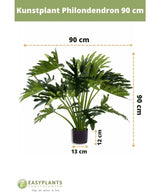 Konstgjord växt Philodendron UV 90 cm i svart kruka, med 90 cm breda blad. Perfekt för alla utrymmen. Krukstorlek: 12 cm hög, 13 cm bred. Easyplants logotyp längst ner.