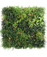 De Kunsthaag Marisa 100x100 cm UV is een weelderige, vierkante groene muur met gemengde bladplanten, varens, geelgroene accenten en verspreide bruinachtige bladeren tegen een effen witte achtergrond.